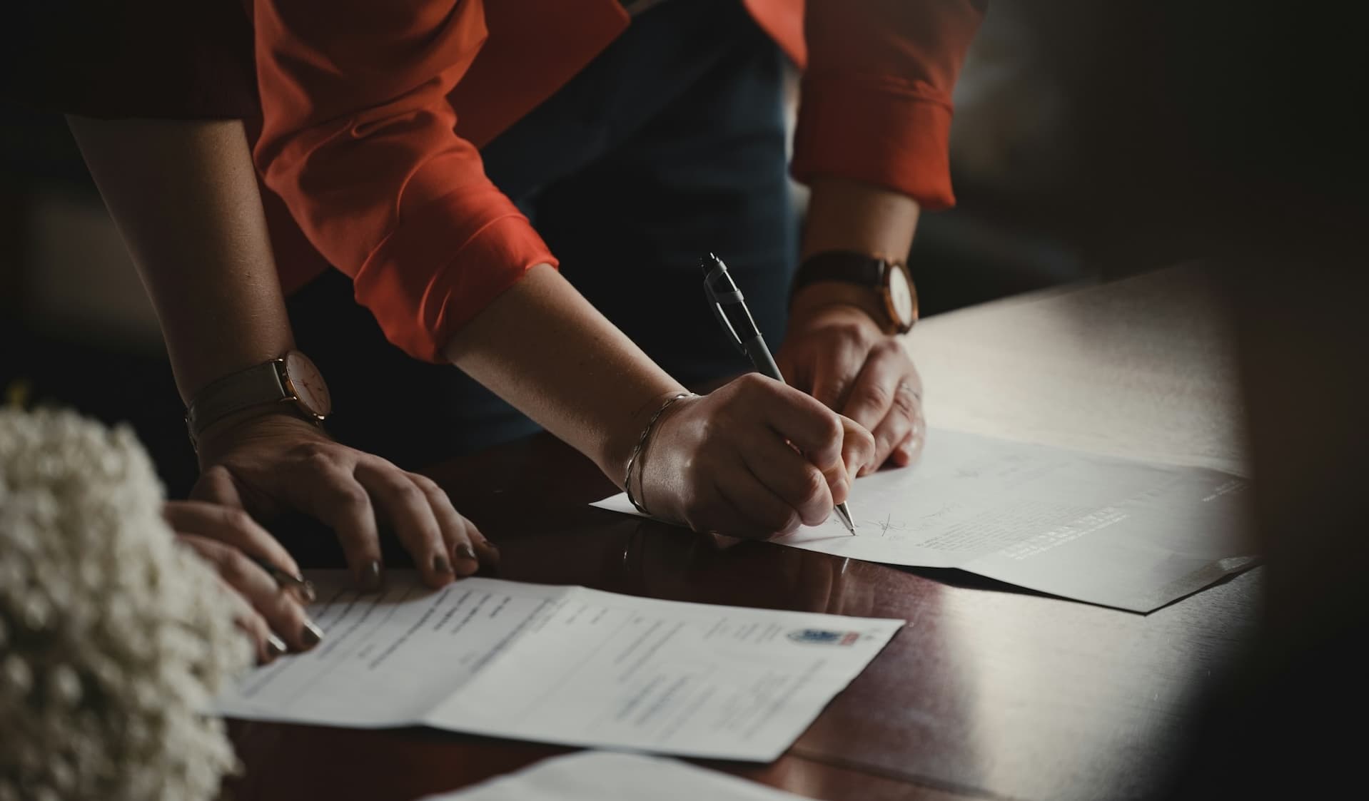 People reviewing and signing partnership documents